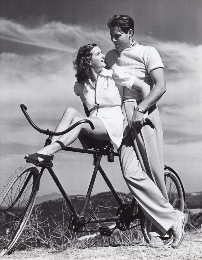 #4 James and Gertrude Ellison rest on a bike, 1938