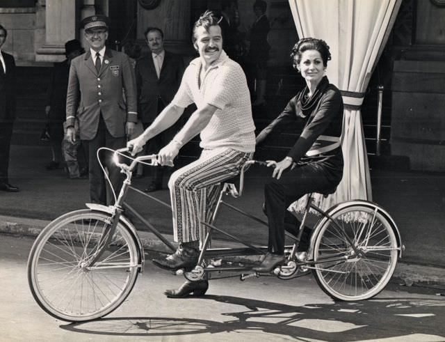 #55 Robert Goulet and Carol Lawrence riding a bike