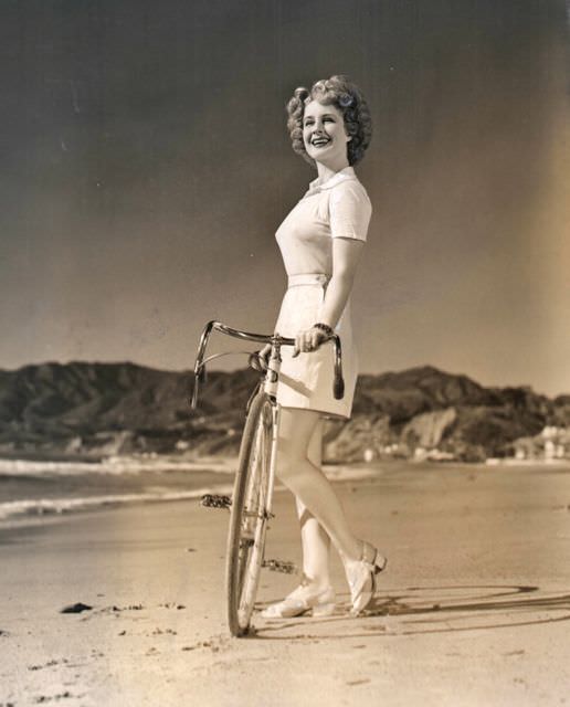 #60 Norma Shearer coasts a bike