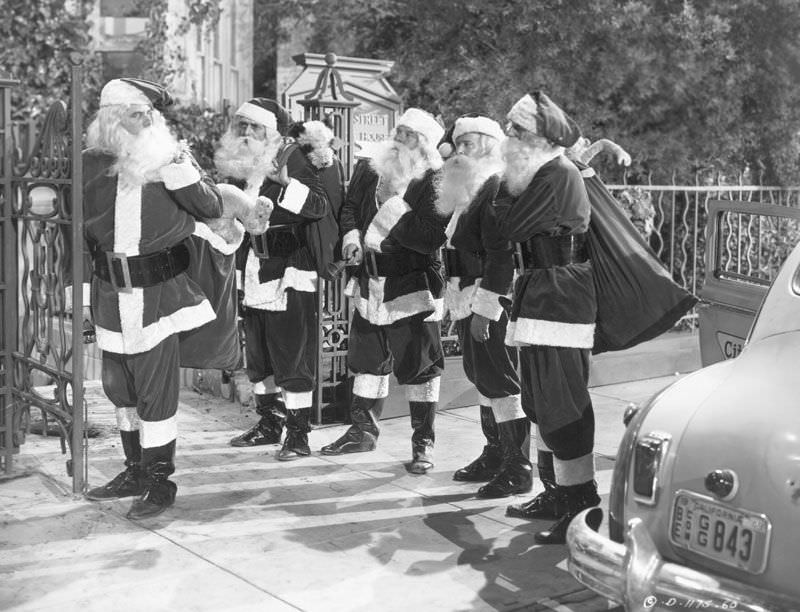 #44 Actor Glenn Ford, left, dressed up as Santa Claus, along with four other actors, for the 1949 film ‘Mr Soft Touch.’
