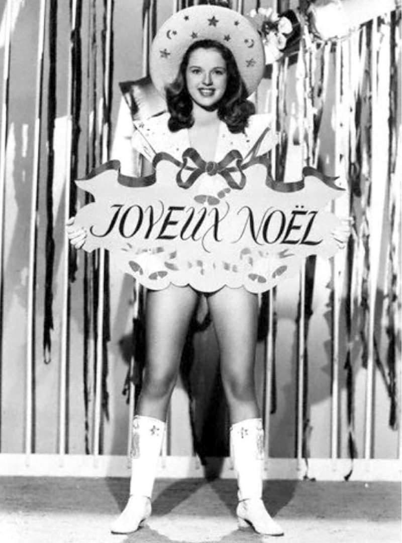 #77 Diana Doris, a British actress, is seen in 1947 with a Christmas greeting written in French.