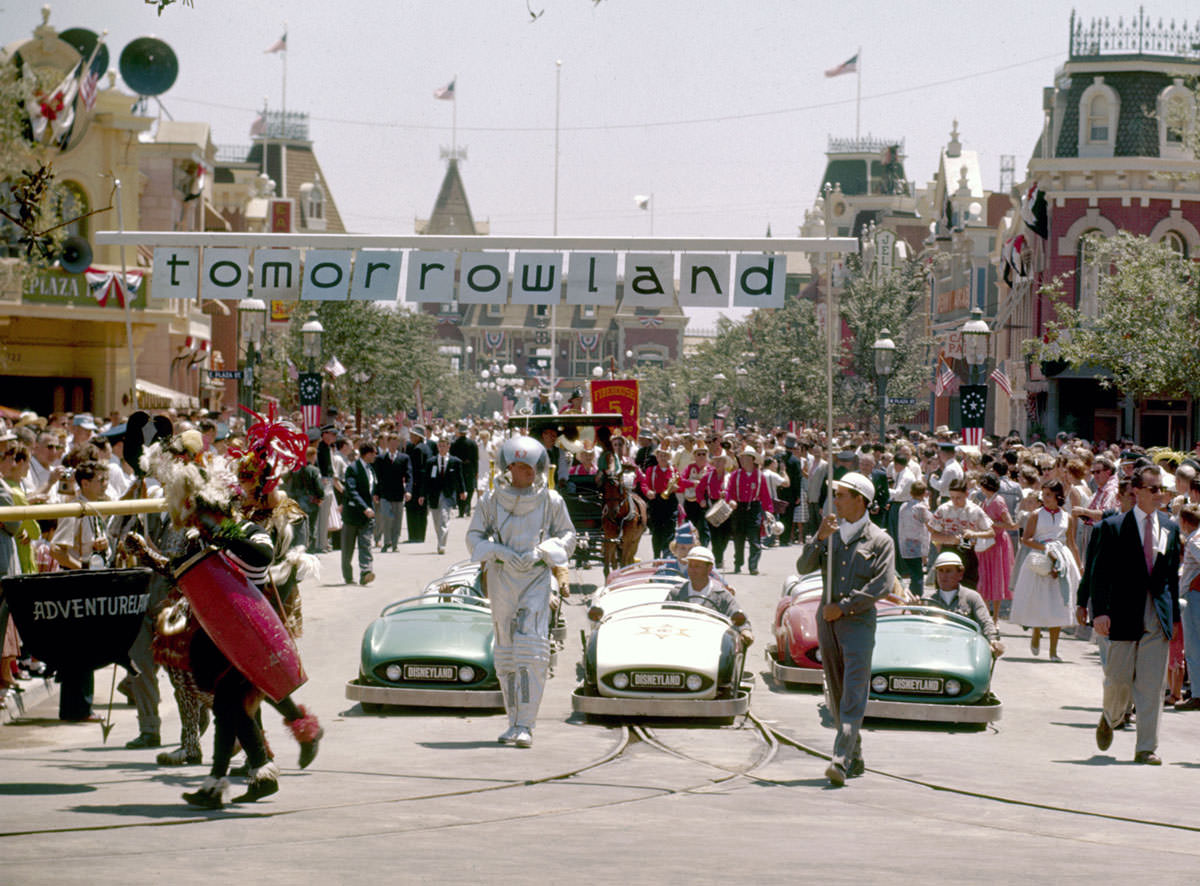 #19 Crowds of people watch the Tomorrowland portion of a parade celebrating the opening of the Disneyland amusement park on July 17, 1955