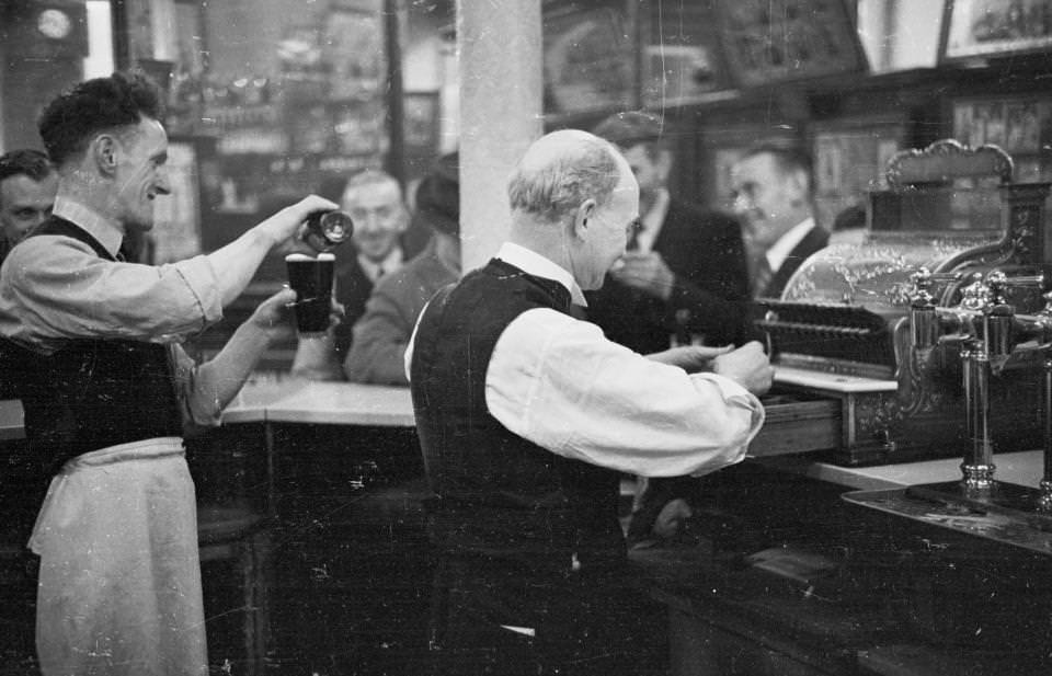 #12 Barmen serve thirsty customers at one of the 174 pubs surrounding the Gorbals area