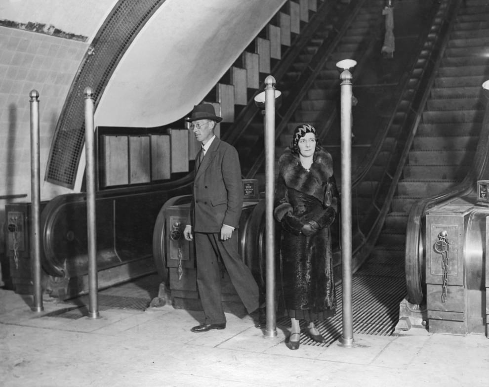 #38 Passengers on an escalator, September 1932. The posts were erected to avoided a crush during rush hours.