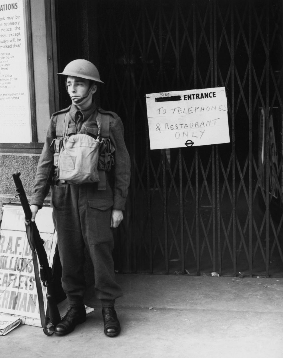 #48 A guard outside a station which has been closed to the public two days after Britain’s declaration of war on Germany, 5th September 1939.
