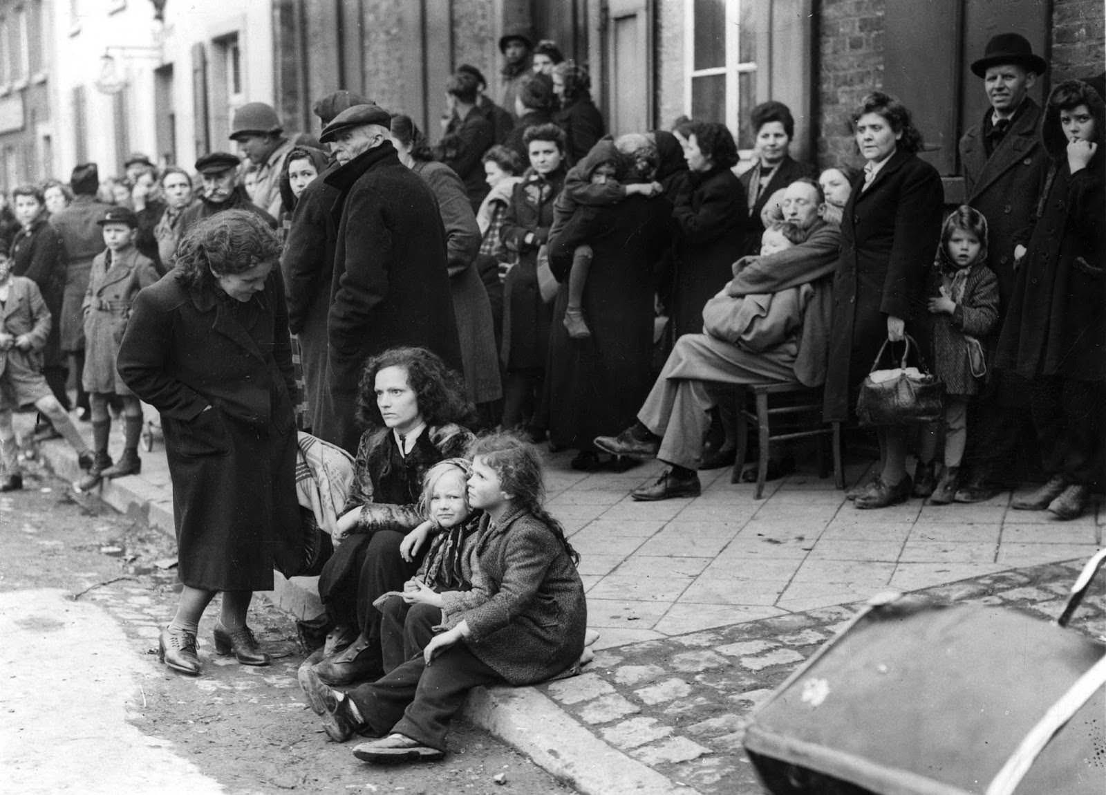 #24 German refugees crowding the market square on Mar. 3, 1945, at Juchen, Germany, a town captured by the U.S. Army at the end of the Second World War.