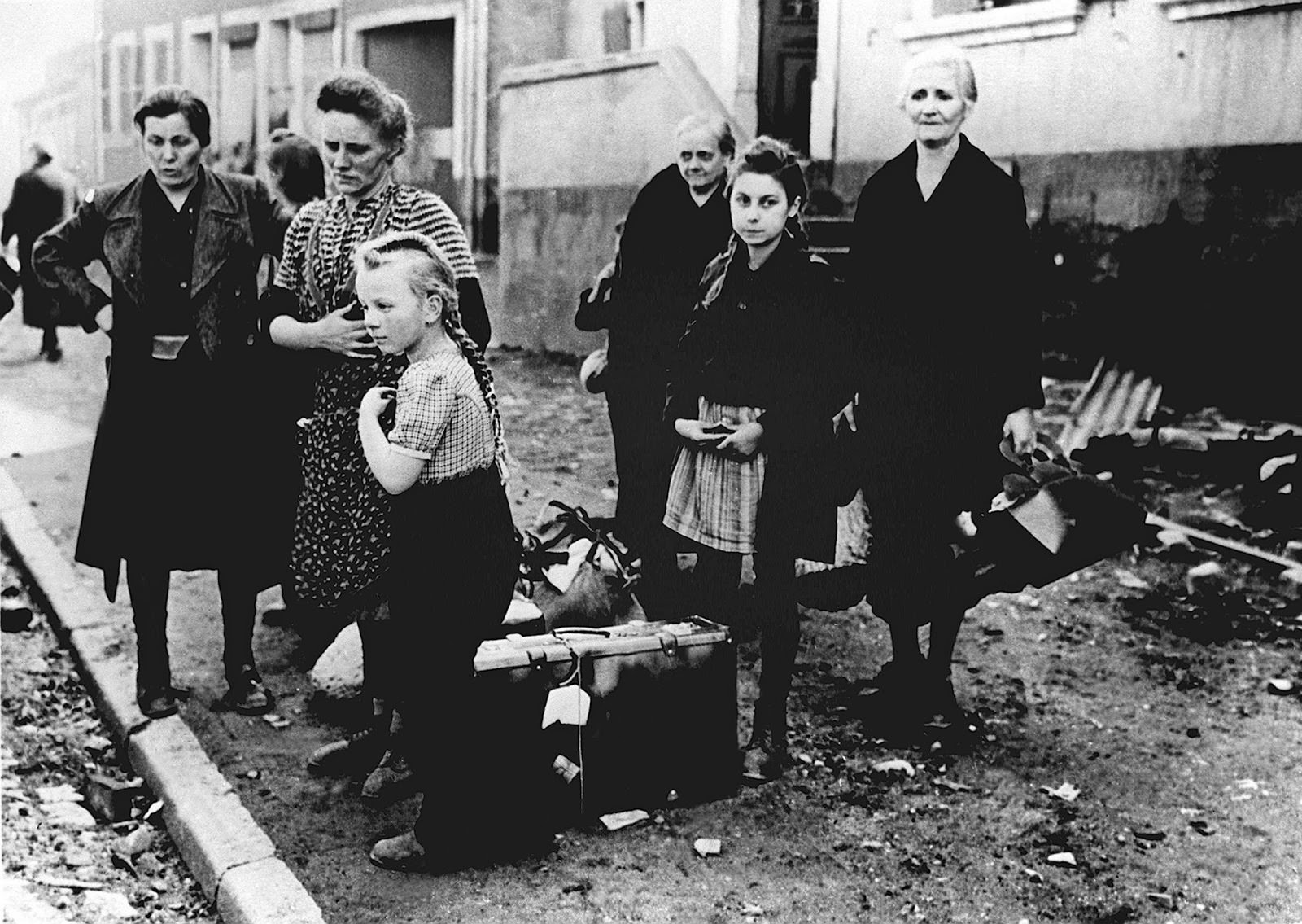 #29 Women and children standing at the roadside in 1945.