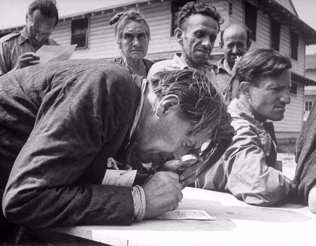 #37 Near-sighted V. Zobotin fills out customs declaration. One elderly Jew got out his prayer shawl, knelt in the midst of all the luggage to give thanks.
