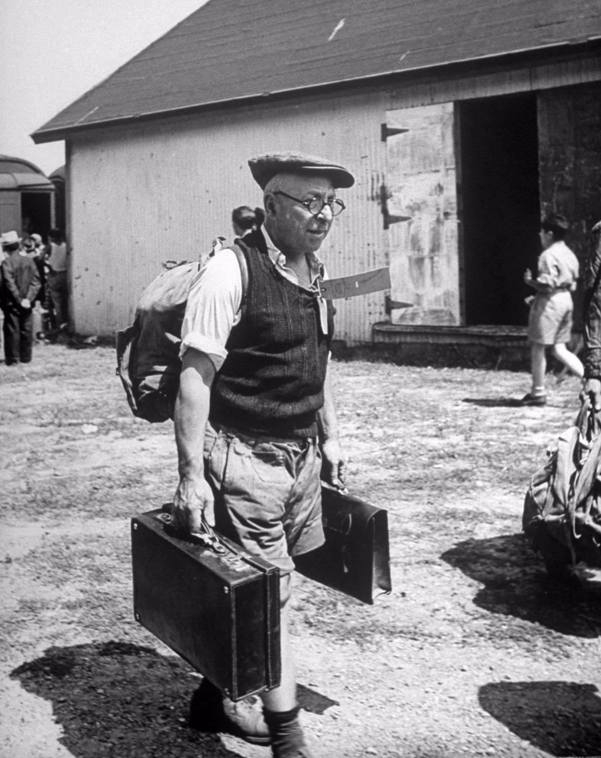 #44 Refugees carried their own luggage to the customs depot. Boys from Oswego were hired to help but many refugees clung to possessions.