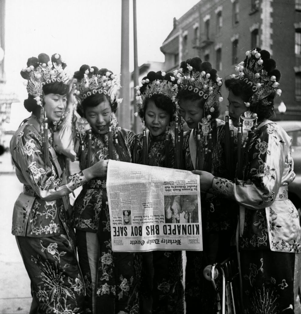 #44 Five women dressed in traditional Chinese clothing read the day’s headlines.
