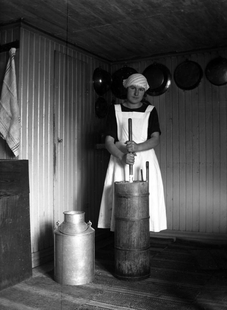 #12 Ulla Göransson churning butter in the old way, ca 1920.