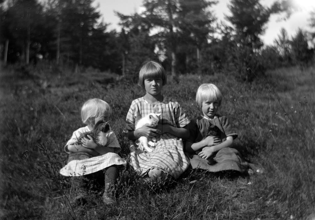 #4 Three little girls with their cats.