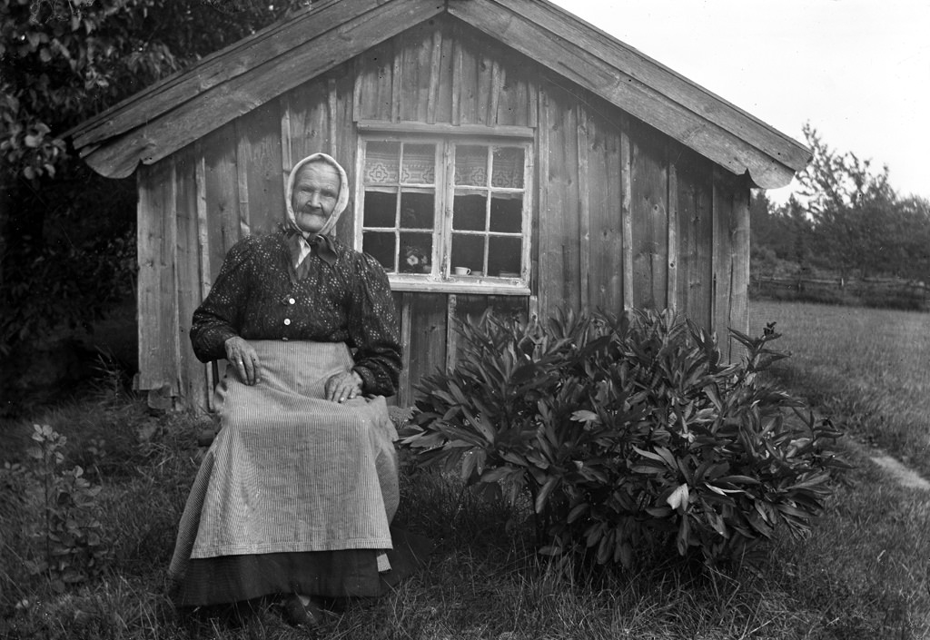 #1 Grandmother sitting in front of her cottage.
