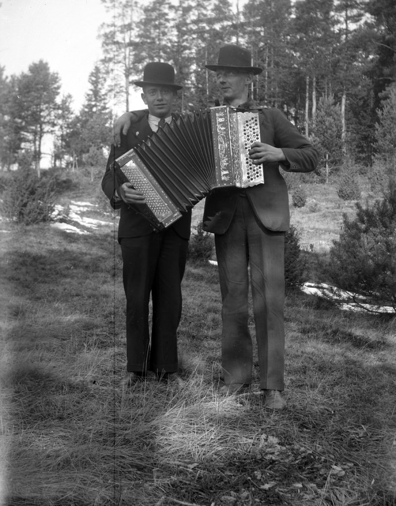 #8 Two men with an accordion.