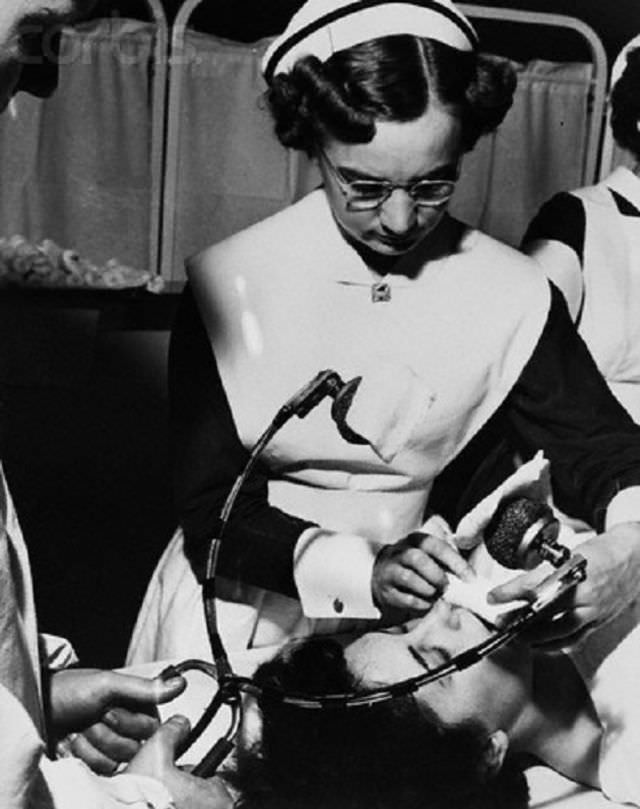 #46 A nurse prepares a patient for electro-shock therapy in Central State Hospital in Kentucky, US in 1951.
