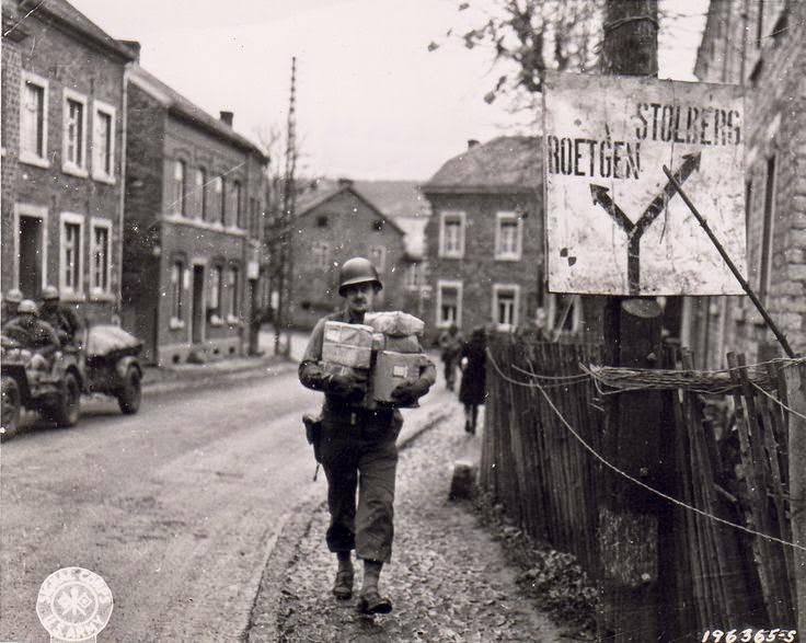 #9 US Army Sergeant Joseph H. Kadlec delivering Christmas packages sent from home, near Aachen, Germany, 14 Nov 1944.