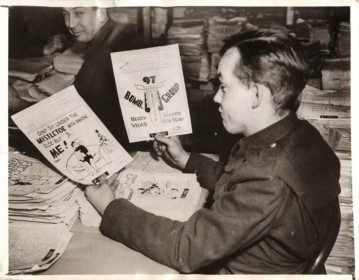 #19 Soldier admires drawings on Christmas V Mail being sent to America from U.S. troops stationed in England, 1942.