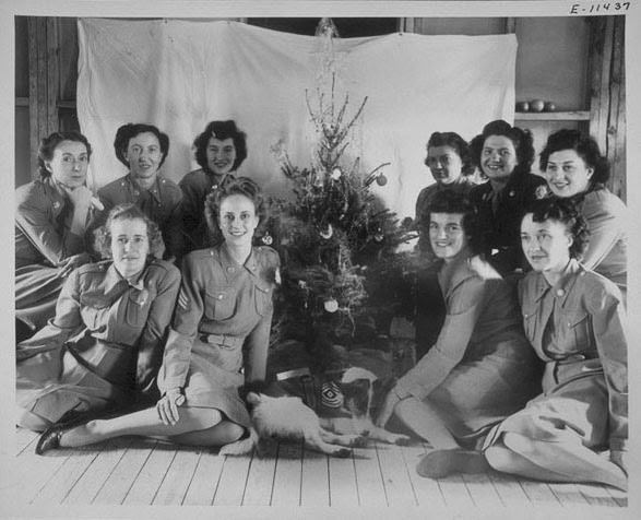 #2 Shown are WACs of the 2nd War Company, Norfolk Air Base, Barracks A, HRPE, seated around a Christmas tree with their mascot dog.