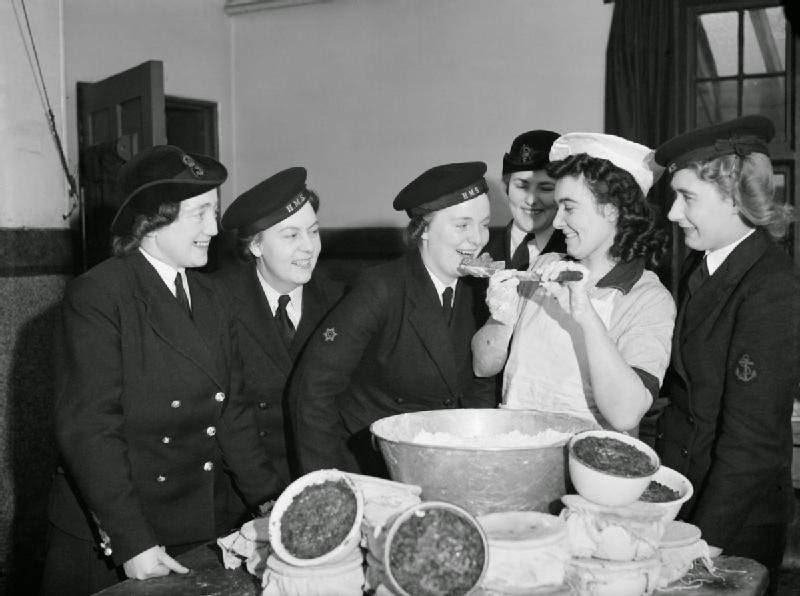 #38 Members of the Women’s Royal Naval Service sampling the Christmas pudding at Greenock in Scotland, 19 December 1942.