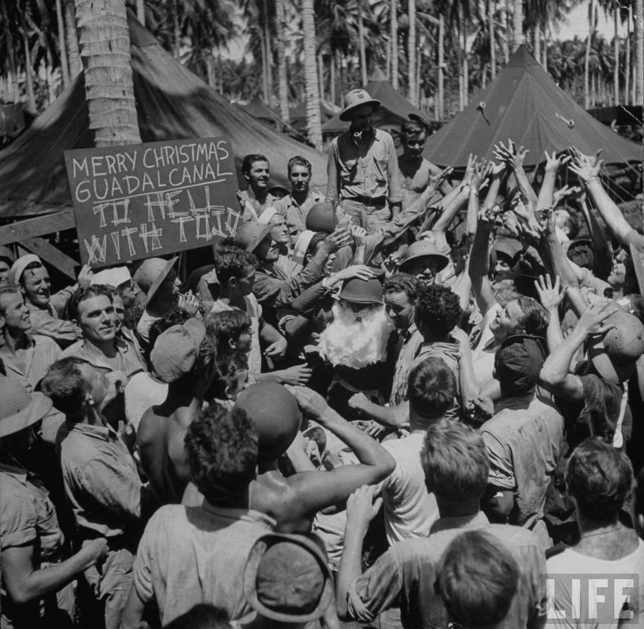 #49 American servicemen (with Santa centre) celebrating Christmas on Guadalcanal, Solomon Islands, 1942.