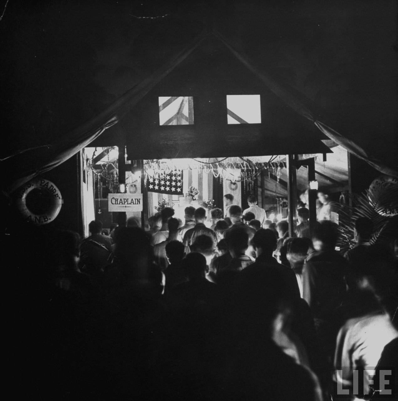 #53 American servicemen at a Christmas midnight mass, Guadalcanal, Solomon Islands, 1942.