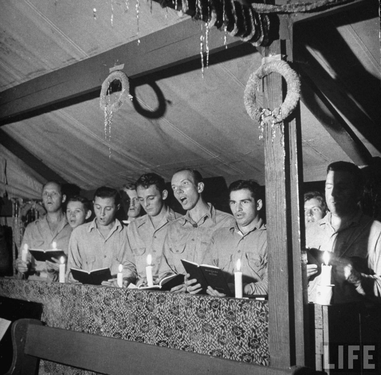 #54 Singing and lighting candles at midnight mass, Guadalcanal, Solomon Islands, 1942.