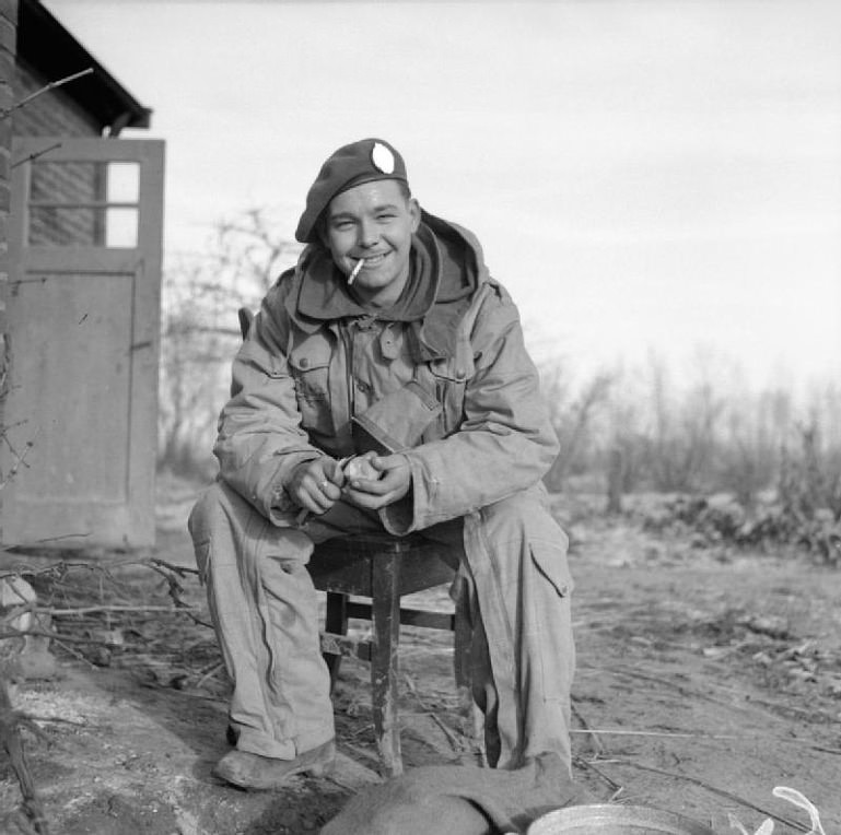 #61 British soldier peeling potatoes for Christmas dinner, Germany, 1944.