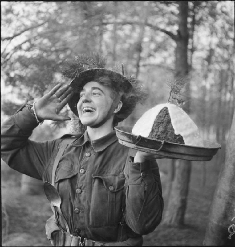 #64 Announcing the Christmas pudding is ready, the Netherlands, 1944.