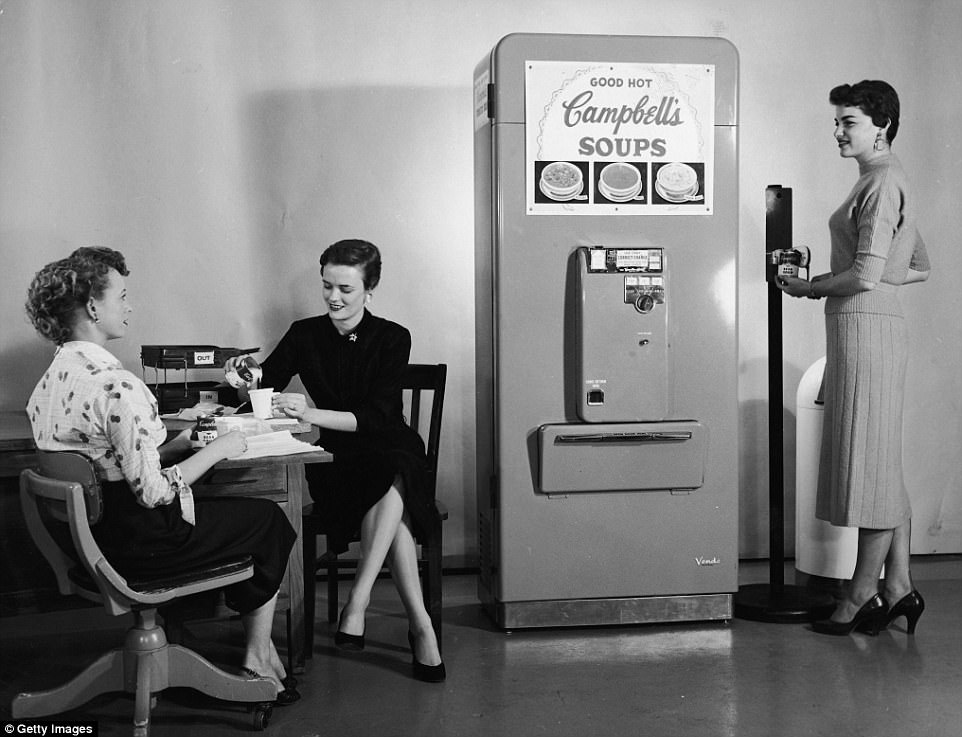 Three women enjoy soup from a Campbell’s Soup vending machine in their office, one of the woman opens a can of soup using another nifty gadget, a floor-mounted can opener, ca. 1950s.