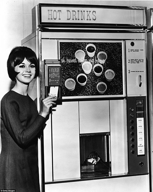 Shoppers could pick up household essentials from this machine. Goods available include Heinz Spaghetti and vegetable soup, Tetley tea, Sugar Puffs, Fray Bentos, Oxo Cubes, soup, light bulbs, mayonnaise and cocoa – all of which could be placed in housewives’ own bags, ca. 1960s.