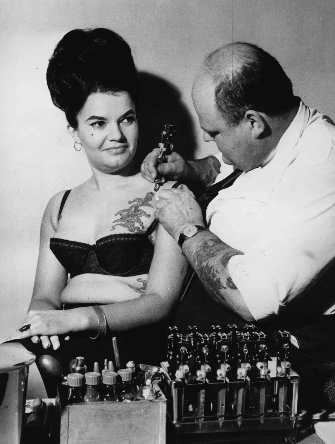 #45 A tattooist works on a chest piece in 1964.