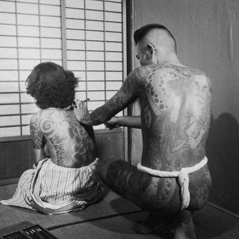 #46 Woman getting a traditional Japanese tattoo.
