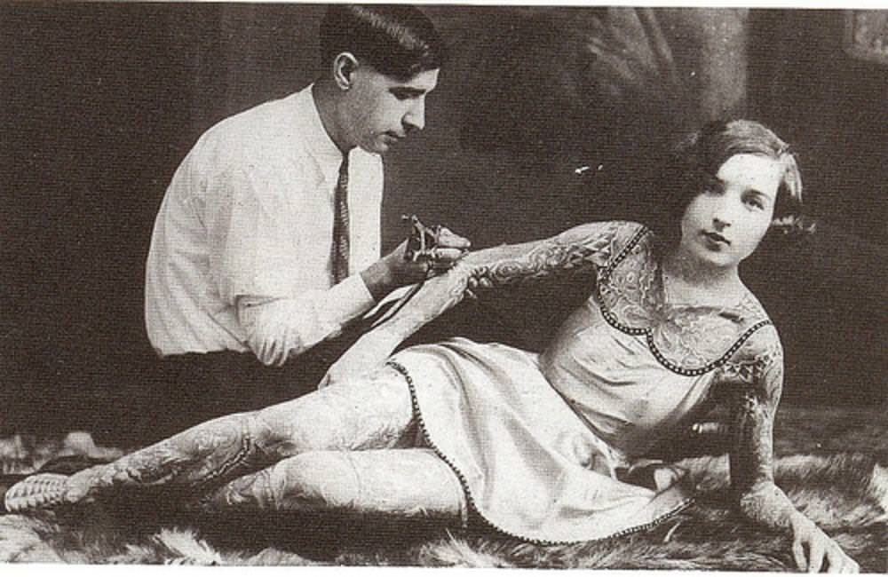 #29 A woman being tattooed, early 1900s
