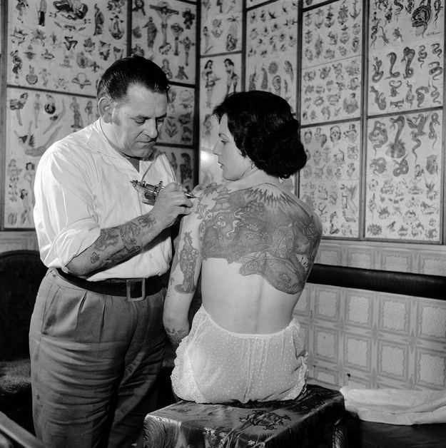 #31 Pam Nash, a champion tattooed lady, with a Japanese garden scene across her back, 1960s.