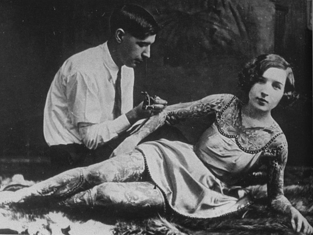 #6 Deafy Grassman tattooing his wife, Stella, ca. 1930s.