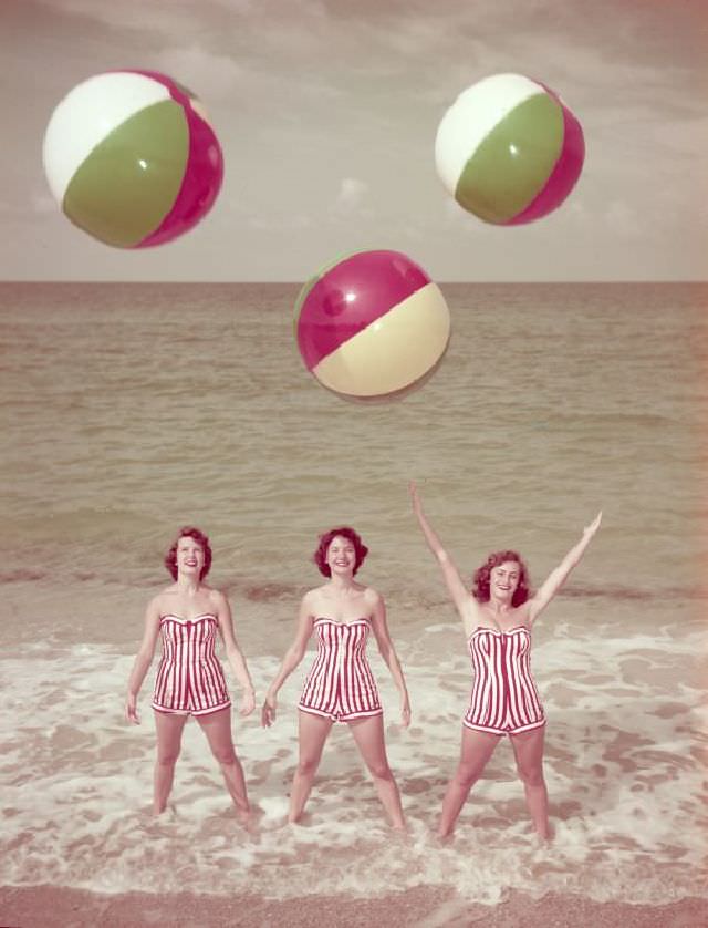 #39 Women modeling bathing suits at the beach, circa 1955