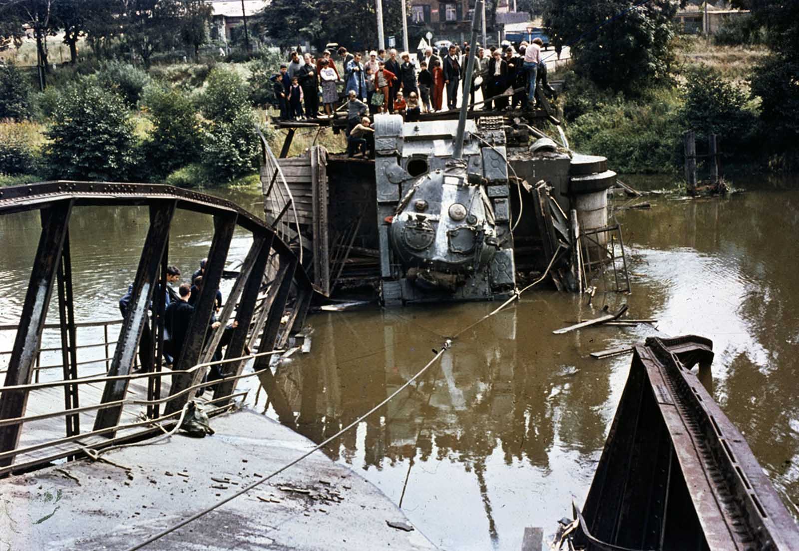 #11 A Soviet tank is out of action after a bridge it was crossing gave way on August 21, 1968.