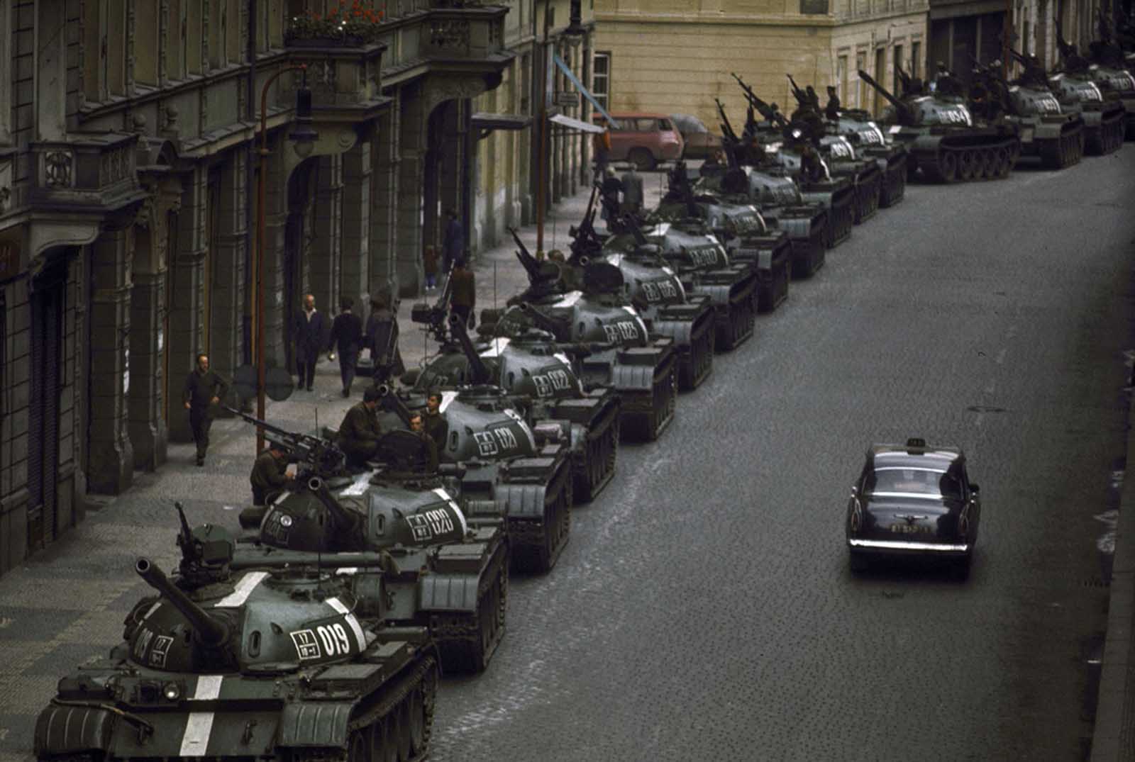 #23 A lone car passes dozens of Soviet tanks during the 1968 invasion of Czechoslovakia.