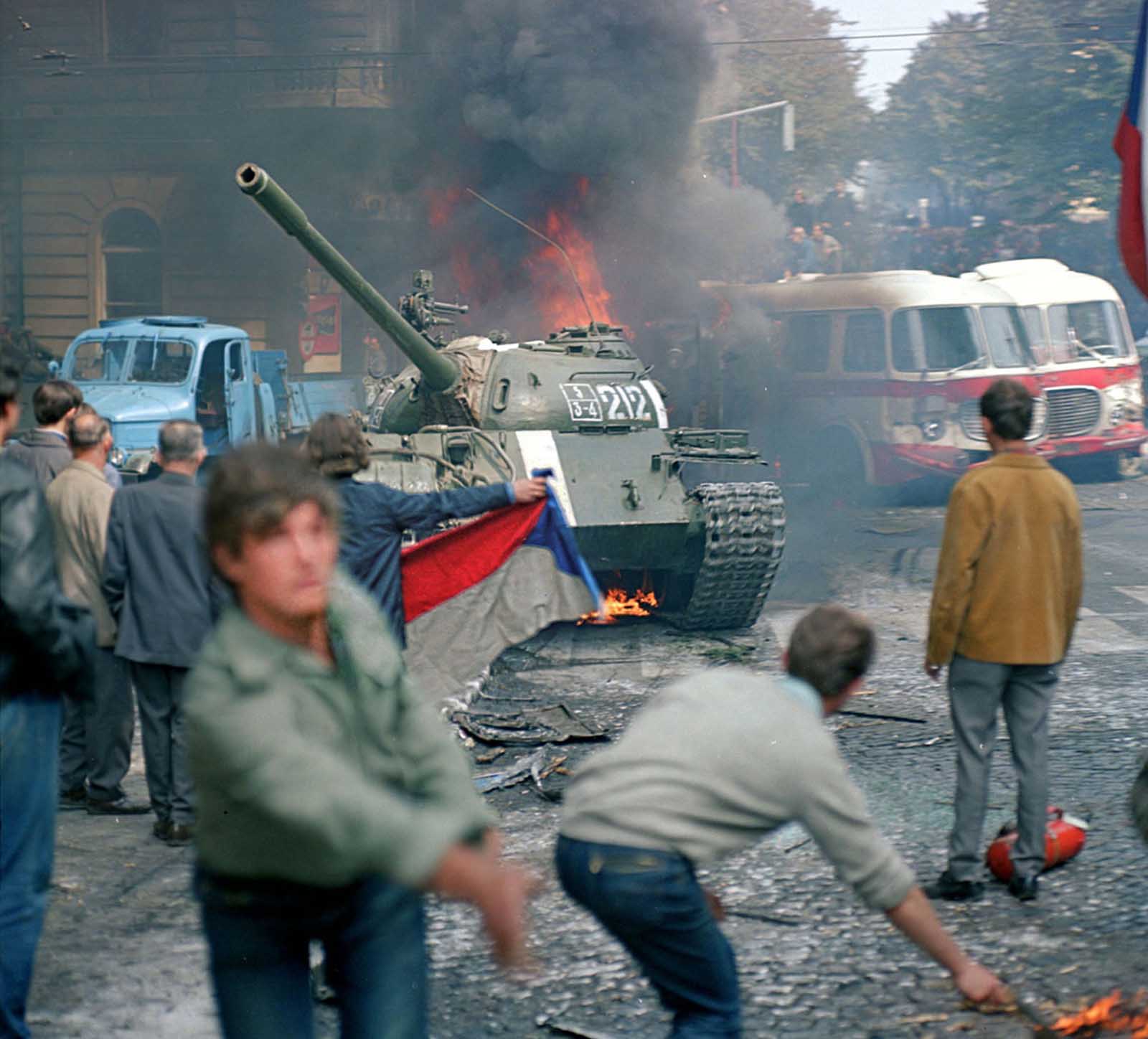 #6 Prague residents, carrying a Czechoslovakian flag and throwing Molotov cocktails, attempt to stop a Soviet tank in downtown Prague on August 21, 1968.