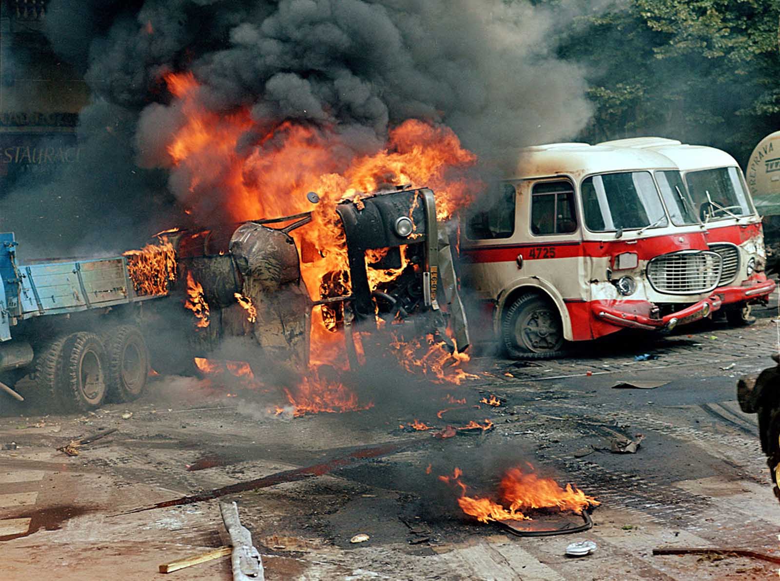 #7 A barricade made from trucks and buses burns in front of the Czechoslovak Radio building, in central Prague, on August 21, 1968.