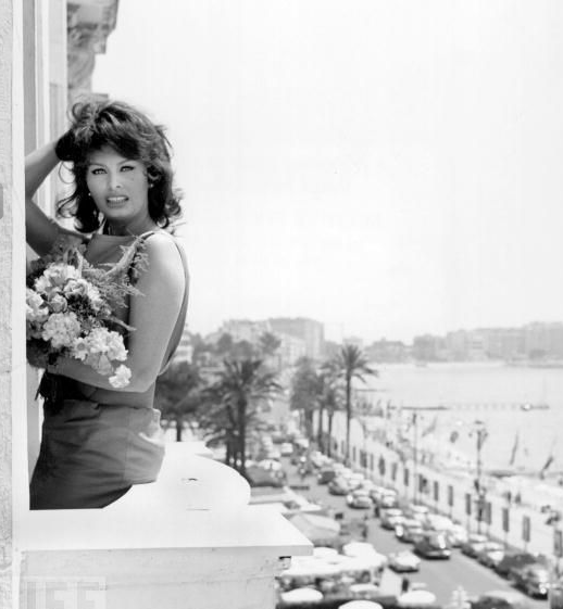 #18 Sophia Loren poses with flowers on the balcony of her Cannes hotel on May 13, 1959.