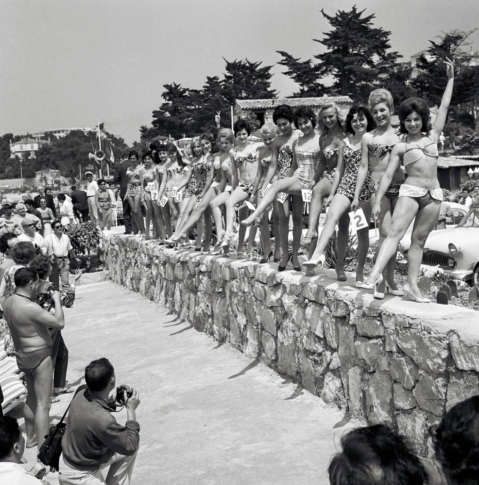 #49 Women dressed in swimming costumes show off their bodies during a beauty contest. The 13th Cannes International Film Festival, France, 1960.