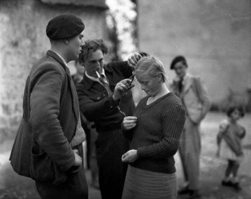 A young woman has her hair cropped by French patriots who accuse her of collaborating with the Germans during the occupation. January 01, 1945.