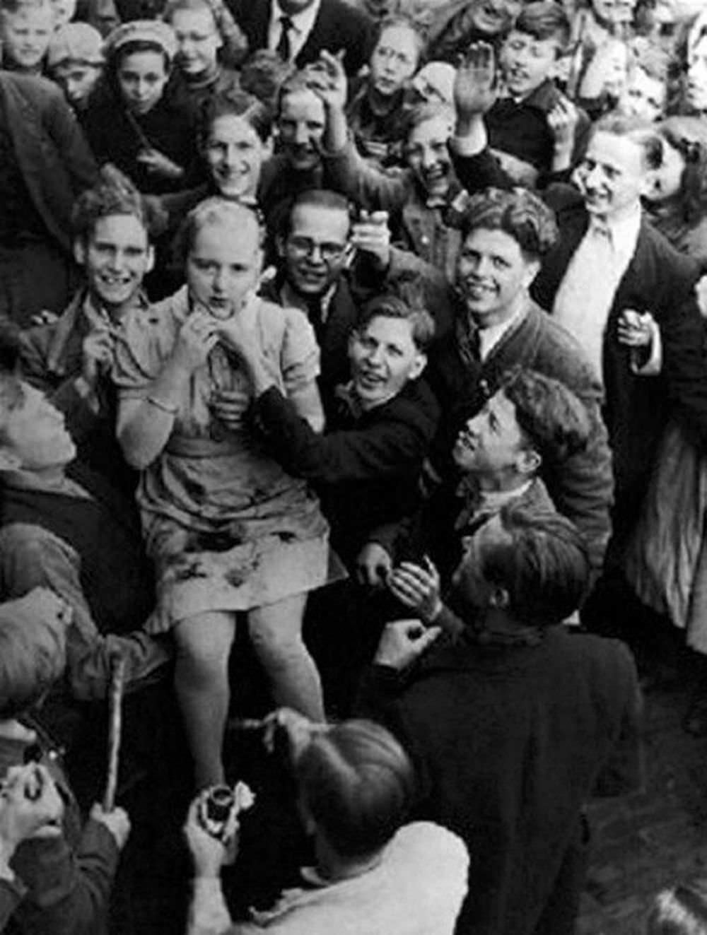 A teenager is brutalized by a mob incited by communist ‘partisans’. Note she is being ‘painted’ by a French ‘artist’ at the bottom of the screen.