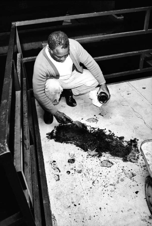 Theatrice Bailey, brother of the motel’s owner, scrapes King’s blood from the balcony on the night of the man’s death.