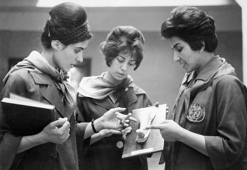 #78 Faculty of Medicine in Kabul of two Afghan medicine students listening to their professor (at right) as they examine a plaster cast showing a part of a human body, 1962.
