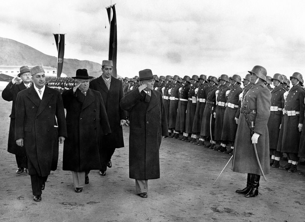 #17 Soviet leader Nikita Khrushchev (black hat), and Marshal Nikolai Bulganin review an Afghan honor guard wearing old German uniforms, on their arrival in Kabul, Afghanistan, on December 15, 1955.