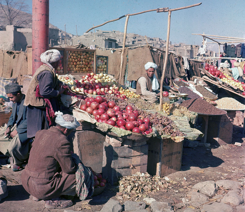 #26 Vendors sell various fuits and nuts at an outdoor market in Kabul, in November of 1961.
