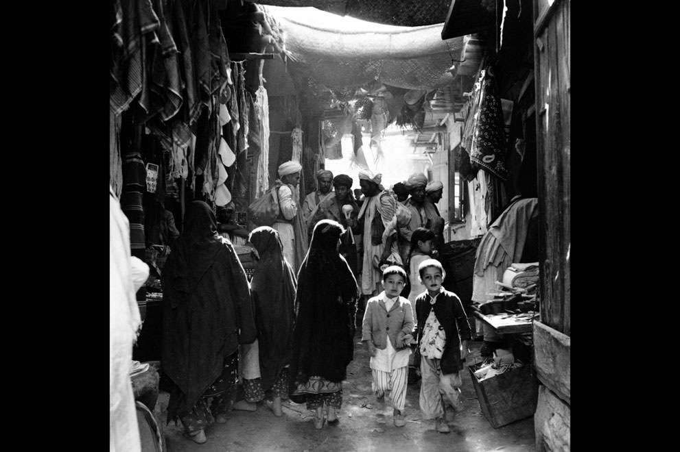 #5 Afghan boys, men, and women, some in bare feet, shop at a marketplace in Kabul, Afghanistan, in May of 1964.