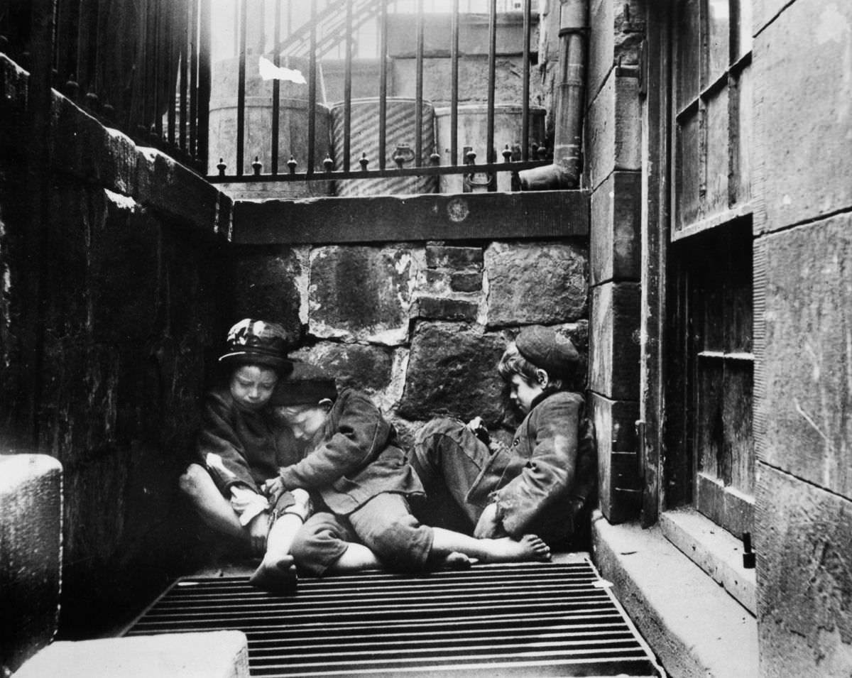 #3 Street children huddle over a grate for warmth on Mulberry Street, 1895